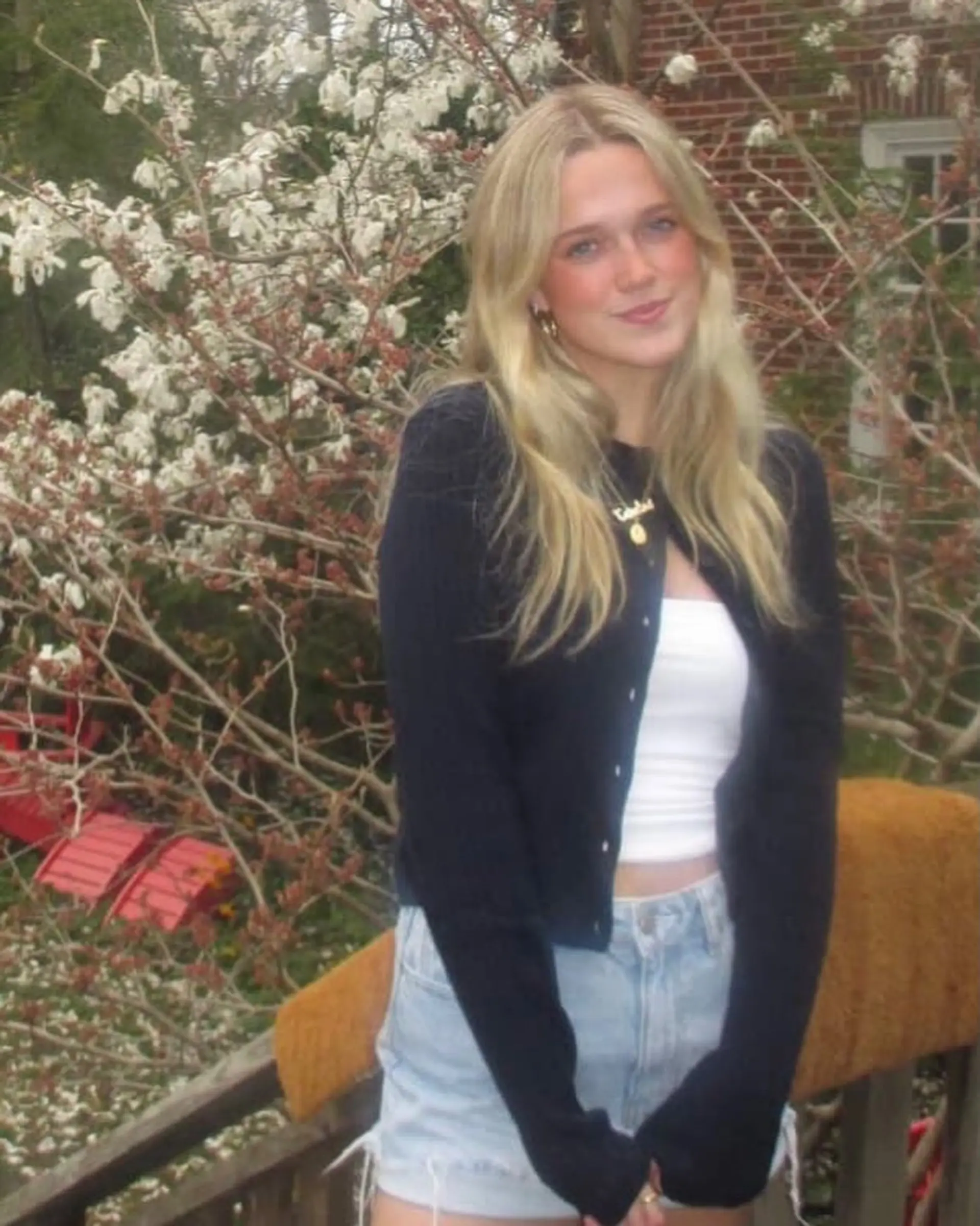 Long, luminous golden blonde hair parted in the center and styled with soft, natural waves. 1