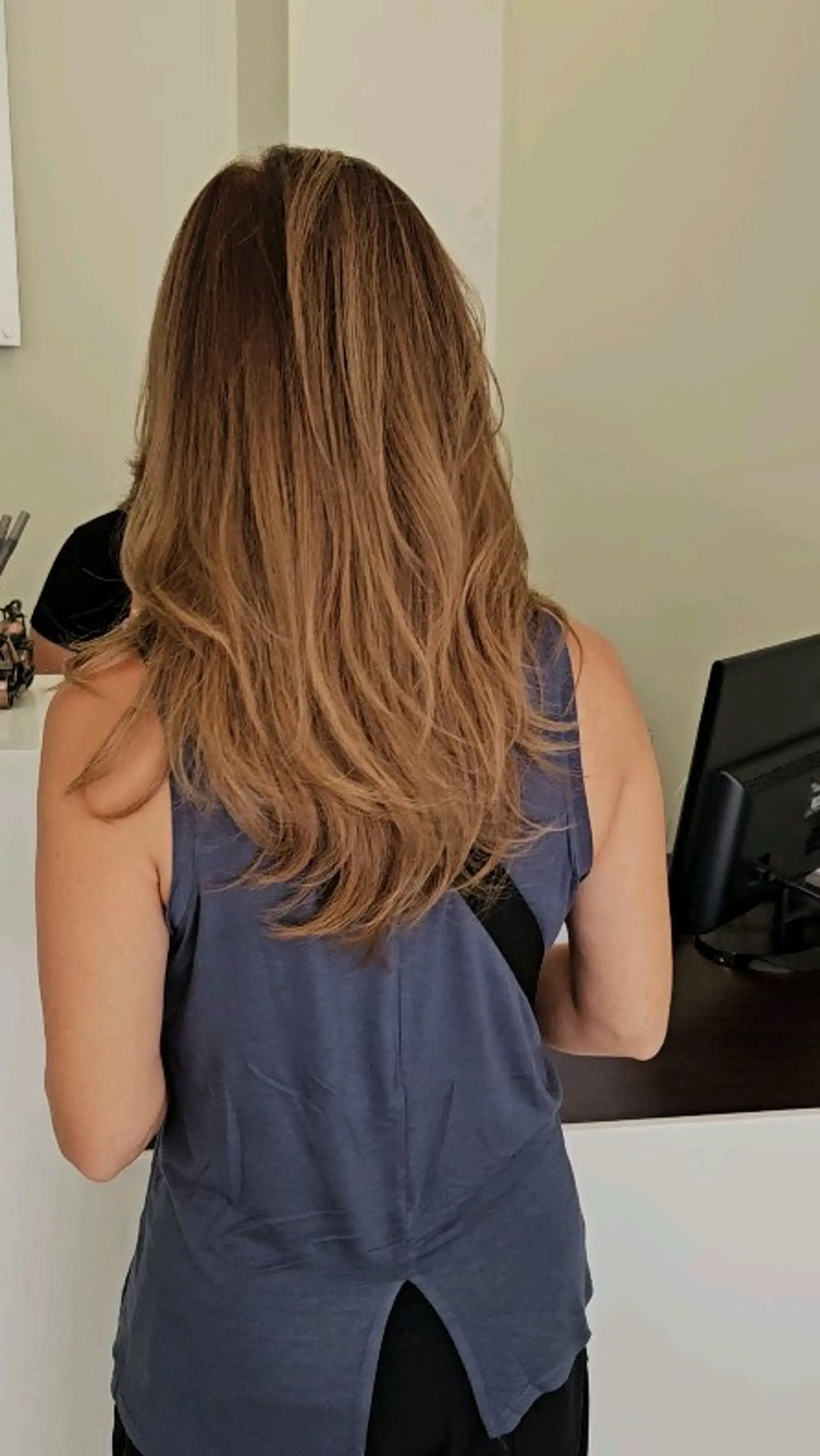 Long honey-toned light brown hair cut in cascading layers with soft, textured waves at the ends. 1