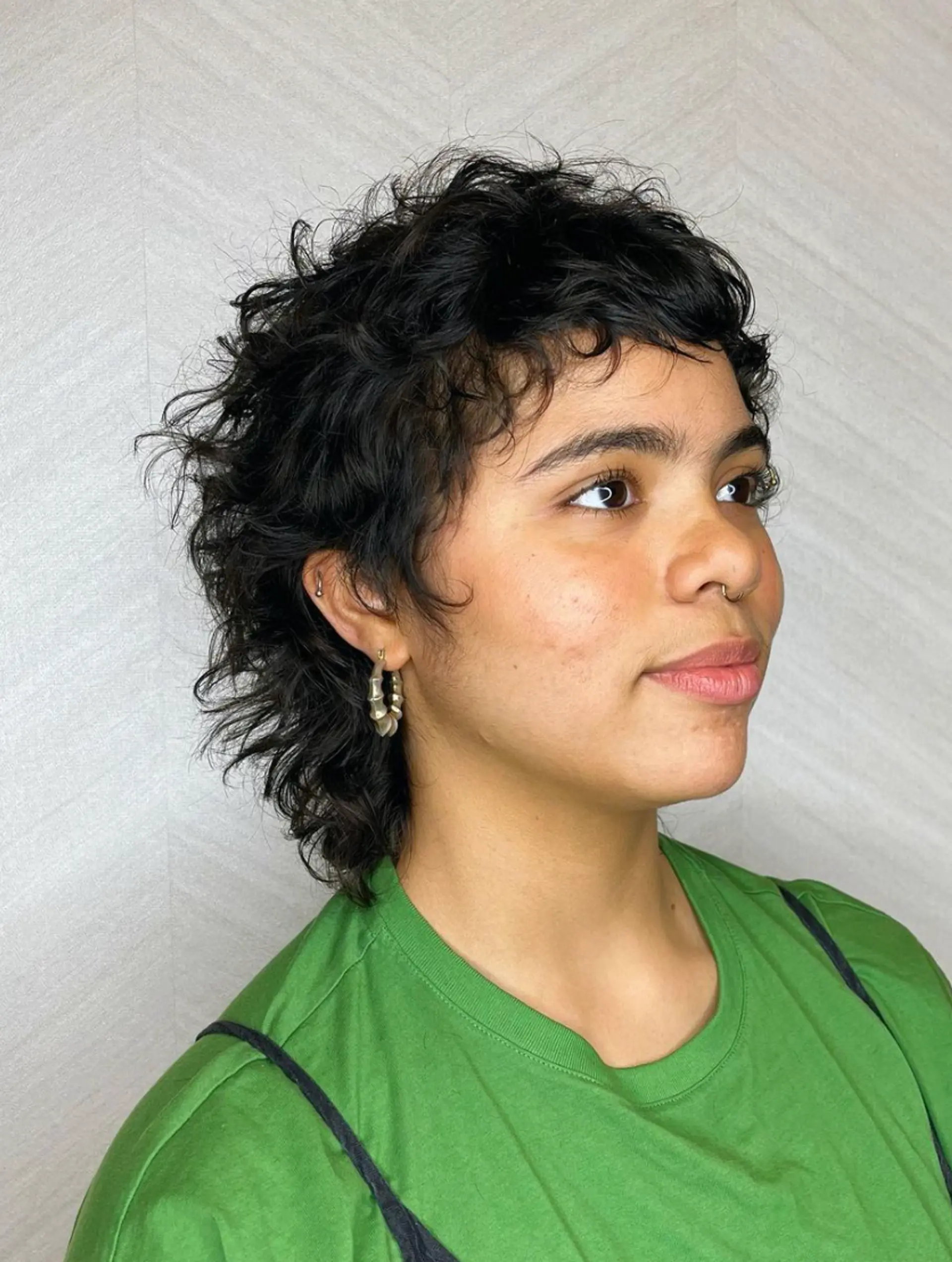 Shaggy, wavy pixie mullet with short, textured layers and a tapered back, featuring a messy, layered fringe.

Cut and style by @juliamannino_hair 1