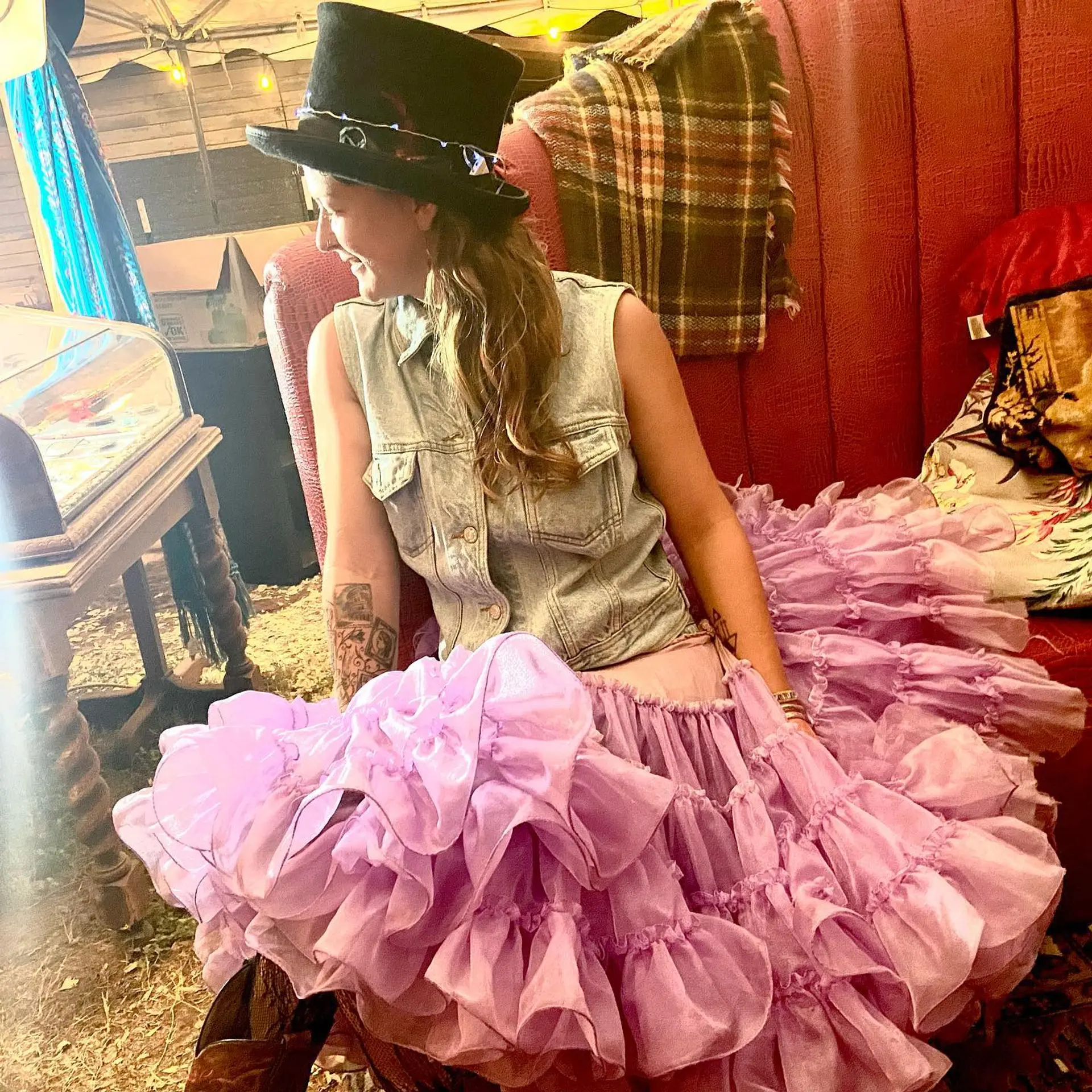 Long, layered curly hair with bangs and subtle balayage. 5