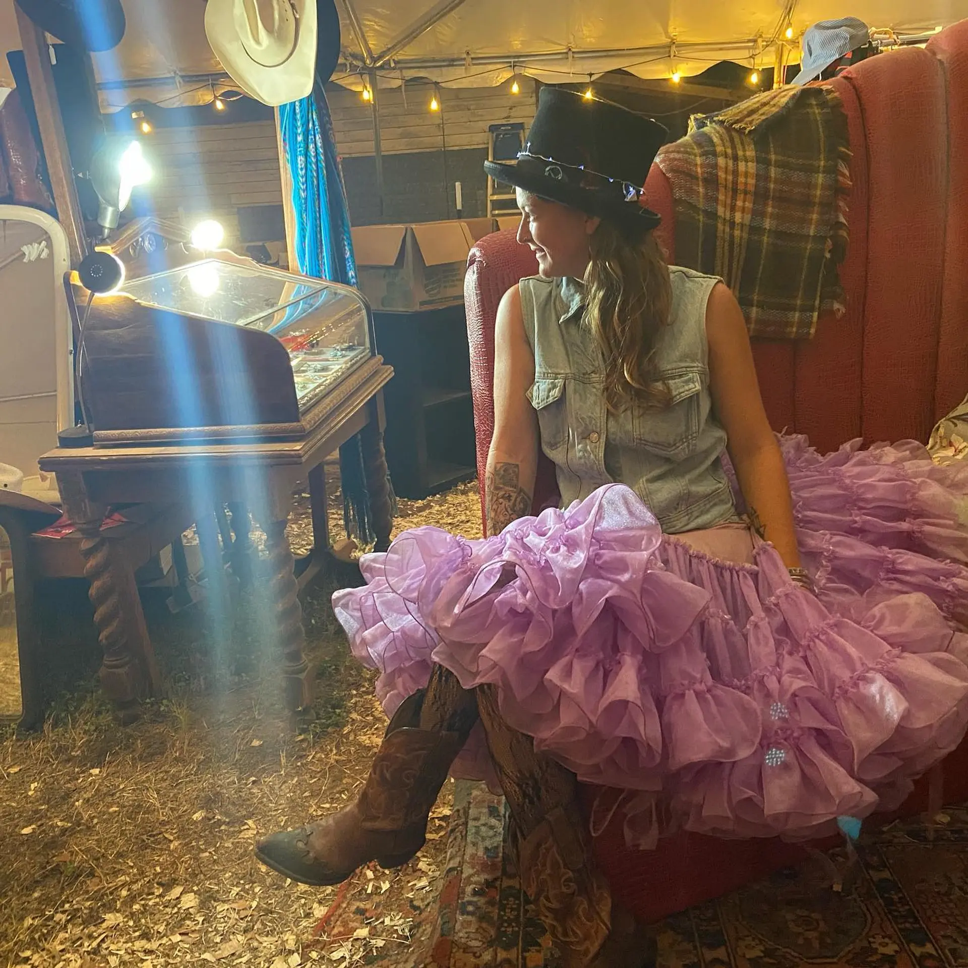 Long, layered curly hair with bangs and subtle balayage. 6