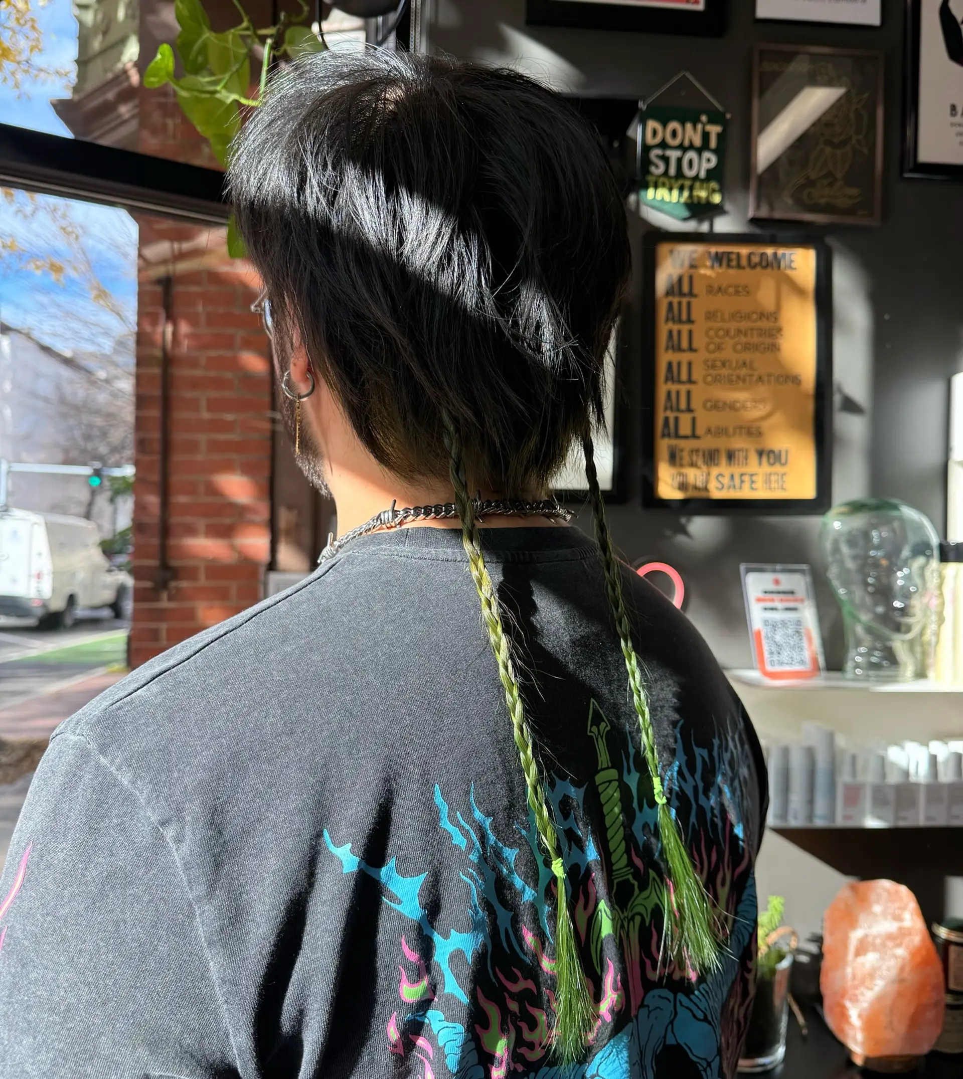 A dark, textured short cut featuring two long, slender lime-green braided rat tails trailing down the back. 1