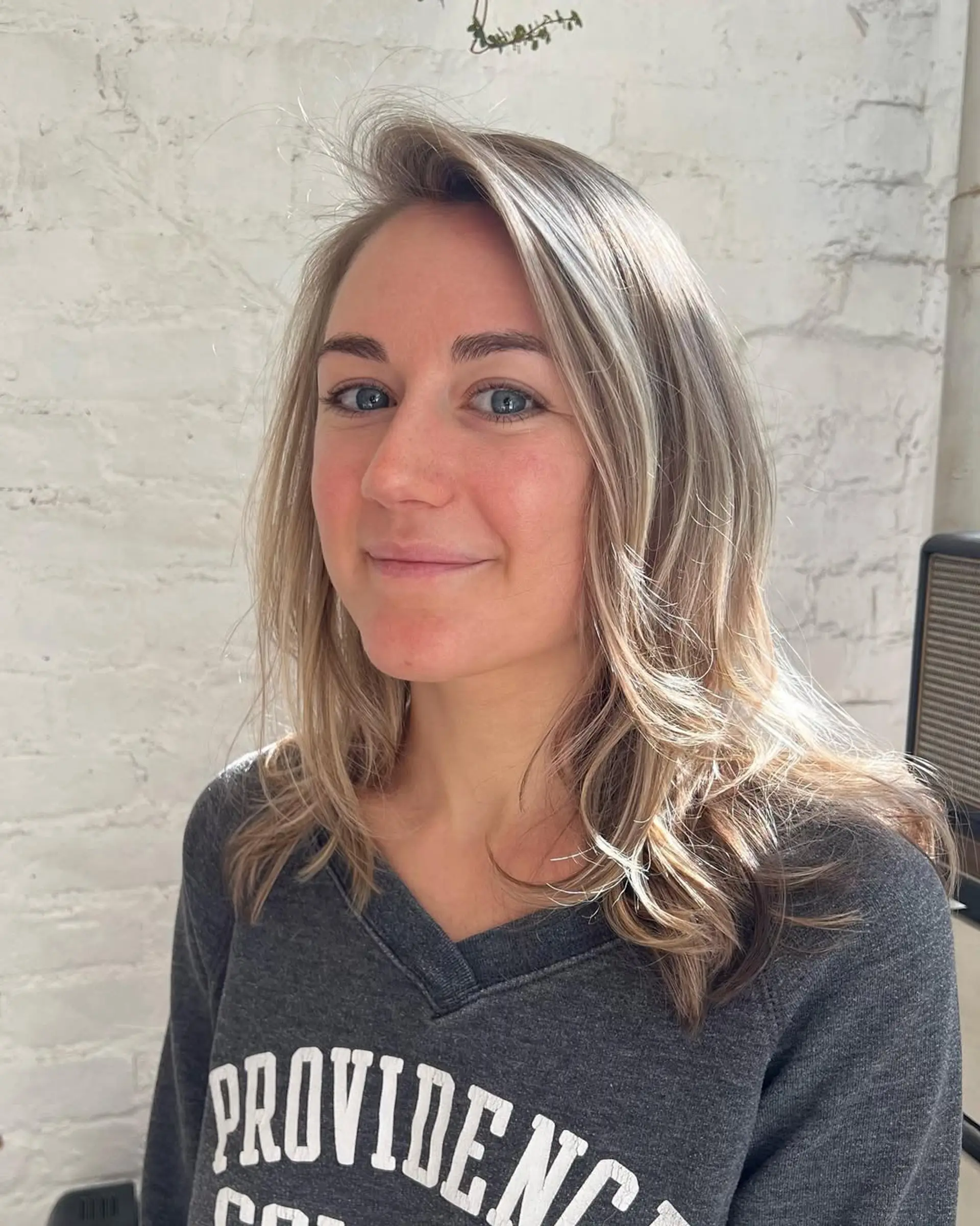 A medium-length long bob with beach waves in a blend of blonde and brown colors. 1